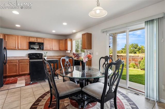 tiled dining room with plenty of natural light