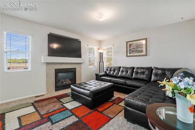 living room with carpet flooring and a fireplace