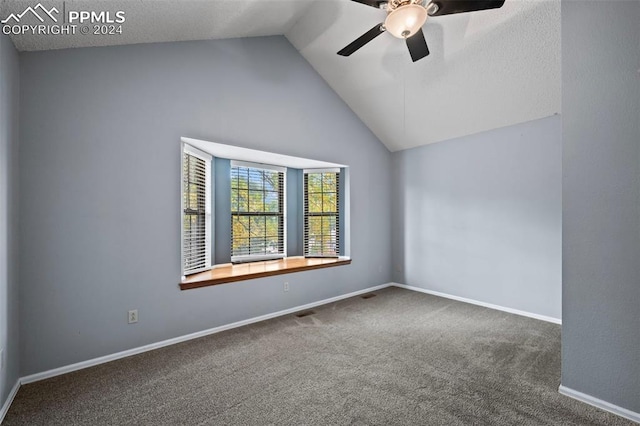 spare room featuring ceiling fan, carpet flooring, and vaulted ceiling