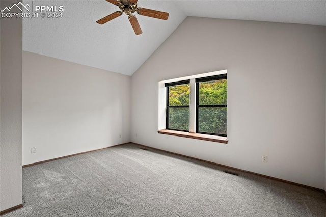 carpeted empty room with ceiling fan, a textured ceiling, and vaulted ceiling