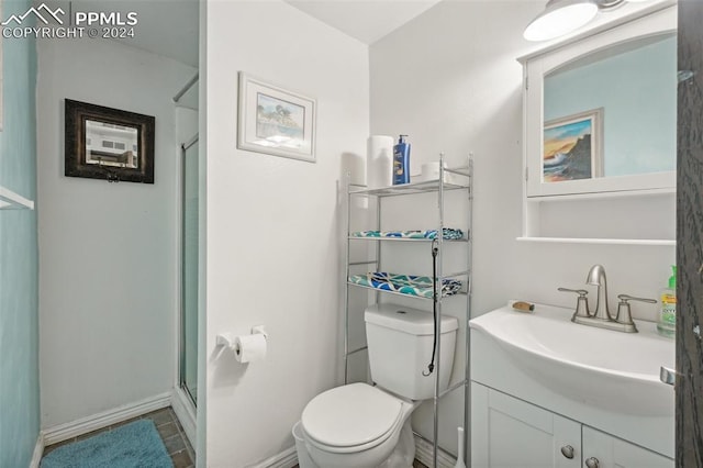 bathroom featuring walk in shower, vanity, and toilet