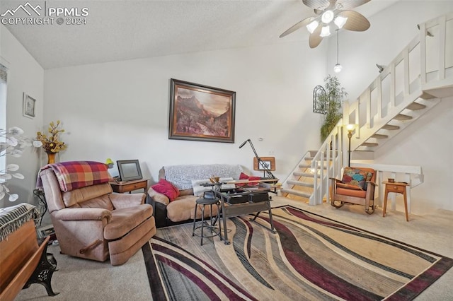 living room featuring vaulted ceiling, ceiling fan, and carpet floors