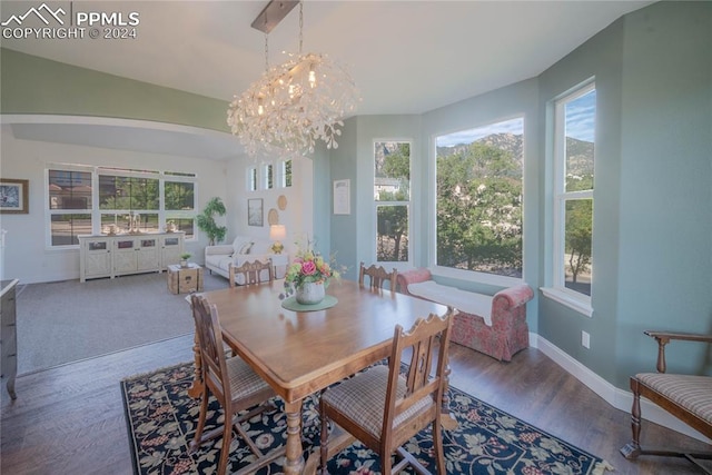 dining room with an inviting chandelier, hardwood / wood-style flooring, and a healthy amount of sunlight