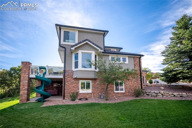 rear view of house with a lawn