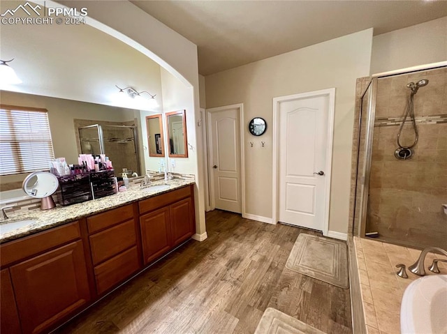 bathroom with vanity, independent shower and bath, and hardwood / wood-style flooring