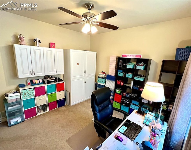 carpeted home office with ceiling fan