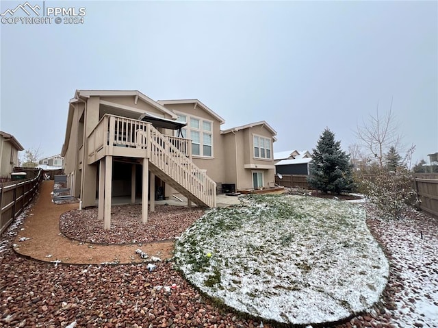 back of house featuring a wooden deck