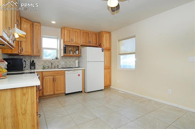 kitchen with ceiling fan, white appliances, sink, backsplash, and light tile patterned floors