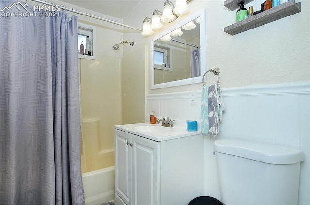 full bathroom with shower / bath combination with curtain, a healthy amount of sunlight, vanity, and toilet