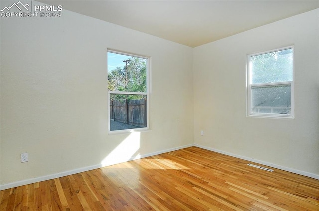 unfurnished room with light hardwood / wood-style floors