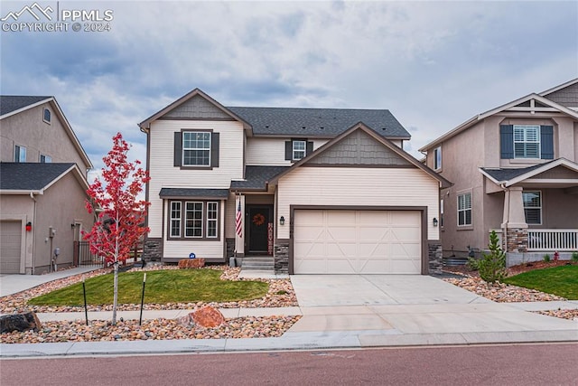 craftsman inspired home featuring a front lawn and a garage