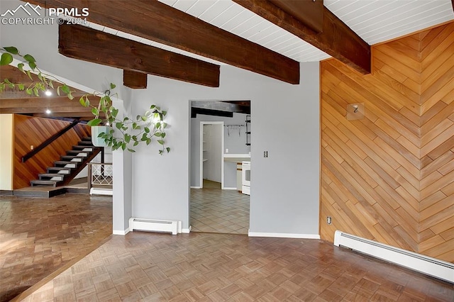 unfurnished room featuring a baseboard radiator, wood walls, and parquet floors