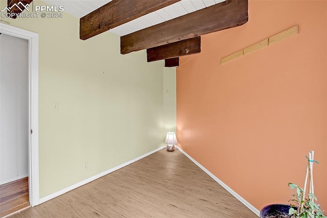 interior space with wood ceiling, light hardwood / wood-style floors, and beamed ceiling