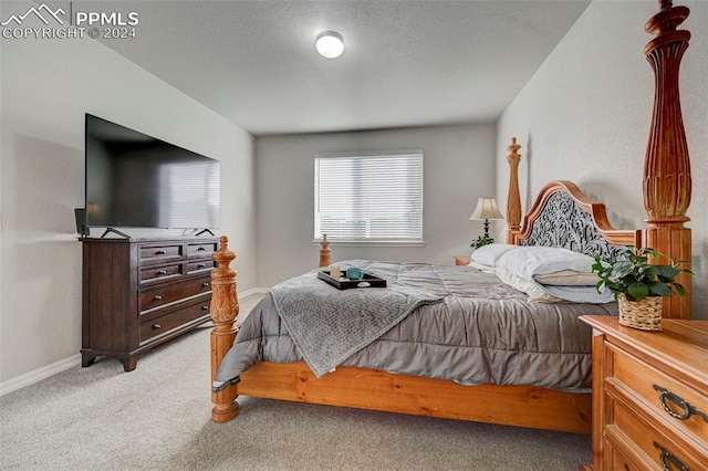 carpeted bedroom with a textured ceiling