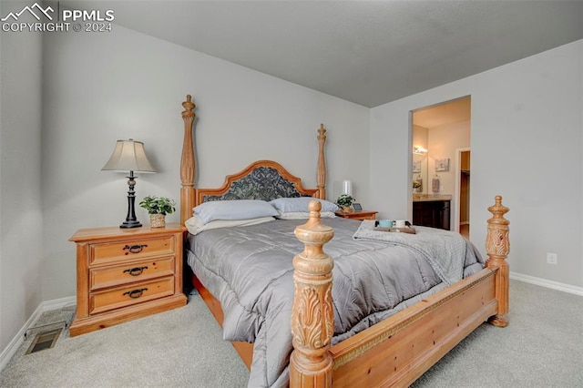 carpeted bedroom with ensuite bath