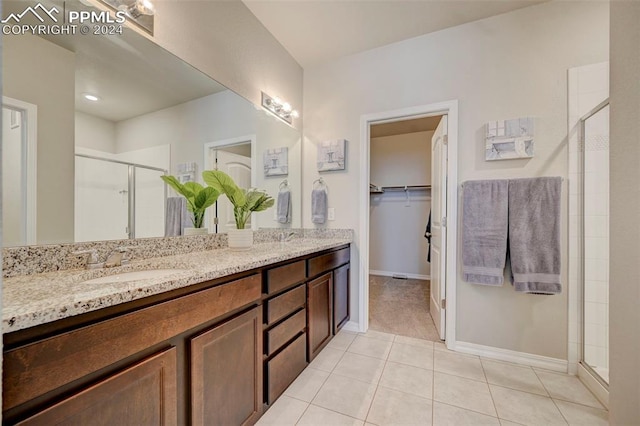 bathroom with vanity, tile patterned floors, and walk in shower