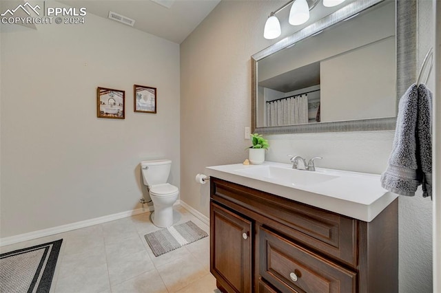 bathroom with vanity, toilet, and tile patterned flooring