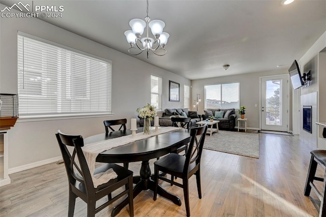 dining area featuring light hardwood / wood-style flooring and an inviting chandelier