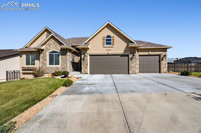 view of front of house with a garage and a front lawn