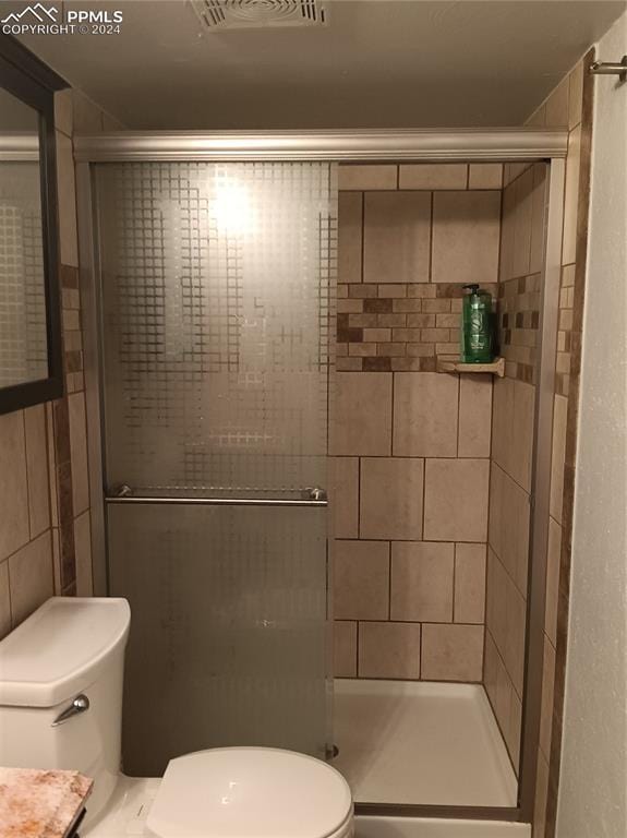 bathroom with walk in shower and toilet