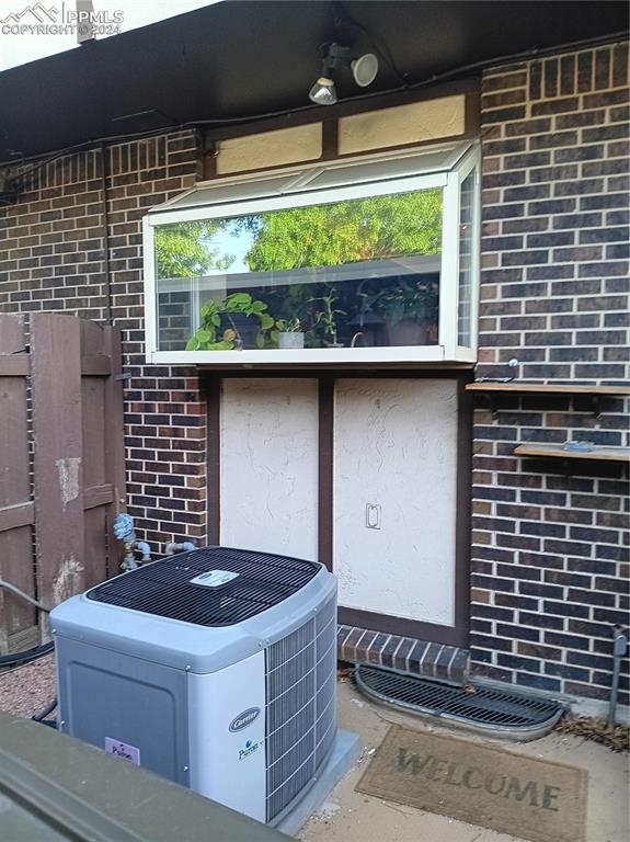 details featuring ceiling fan, central AC unit, and concrete flooring