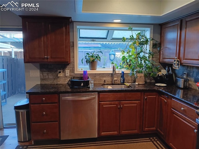 kitchen with plenty of natural light, sink, decorative backsplash, and stainless steel dishwasher