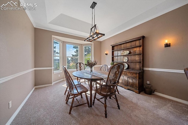 carpeted dining space featuring crown molding