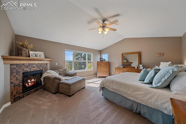 bedroom with lofted ceiling, ceiling fan, a tile fireplace, and carpet flooring