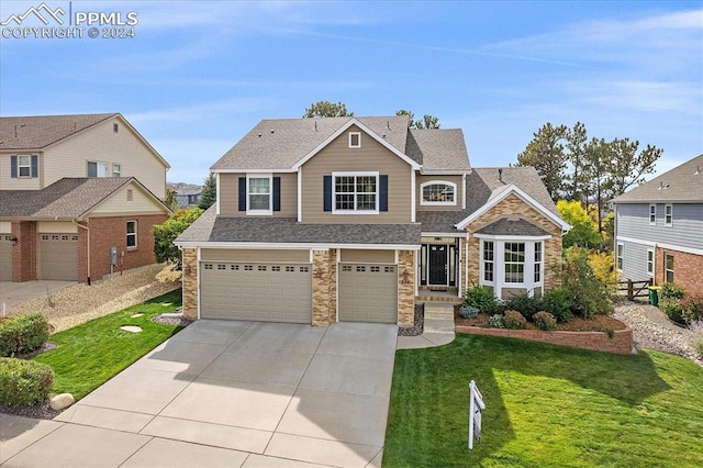 craftsman-style home featuring a front lawn and a garage