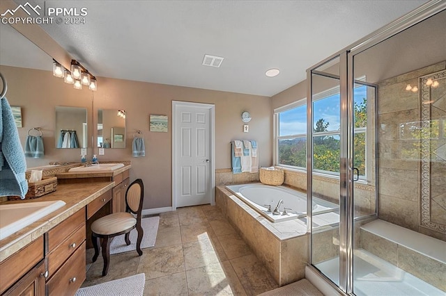 bathroom featuring tile patterned flooring, separate shower and tub, and vanity