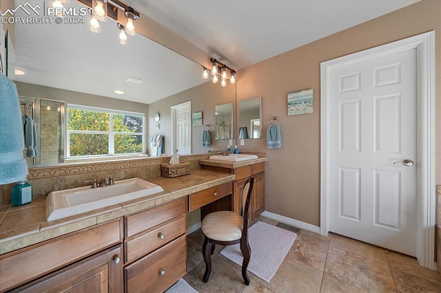 bathroom featuring walk in shower, vanity, and tile patterned flooring