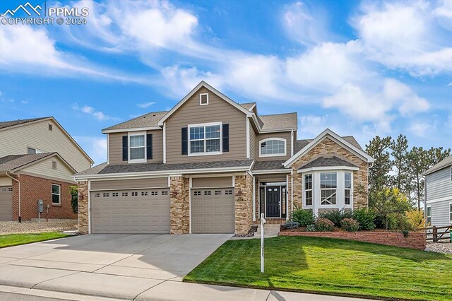 view of front of house with a front lawn and a garage