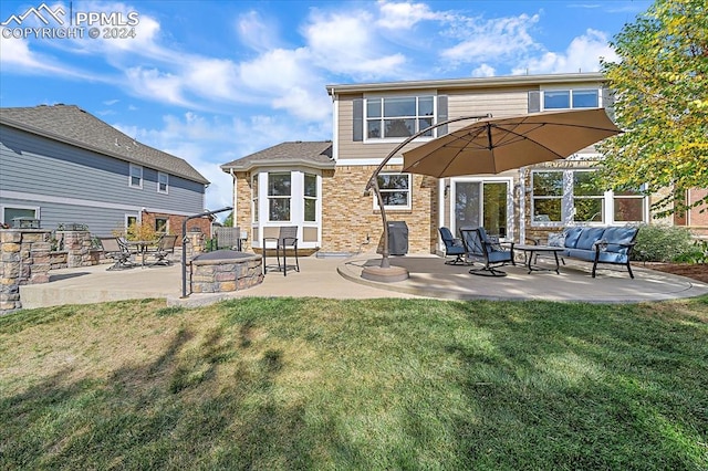 rear view of house with a lawn and a patio area