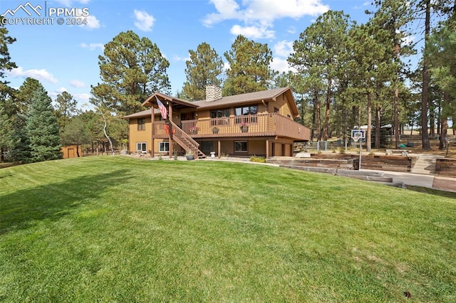 back of property featuring a lawn and a wooden deck