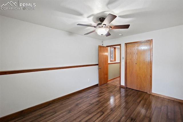 10760 Hardy Rd, Colorado Springs, CO 80908 - unfurnished bedroom with dark wood finished floors, a closet, a ceiling fan, and baseboards