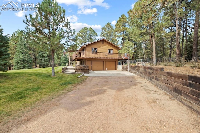 10760 Hardy Rd, Colorado Springs, CO 80908 - rustic home featuring a garage, driveway, a deck, fence, and a front yard