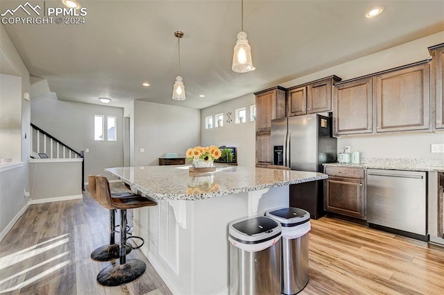 kitchen with a healthy amount of sunlight, a center island, and a kitchen bar