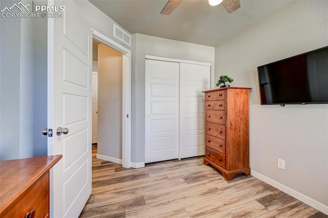 bedroom with a closet, ceiling fan, and light hardwood / wood-style flooring