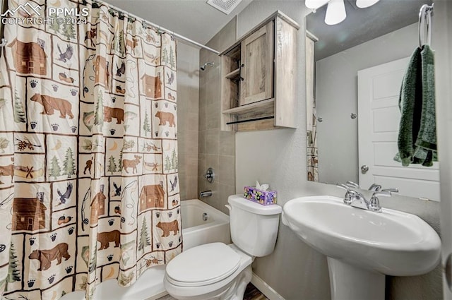 full bathroom featuring sink, shower / bath combo, and toilet