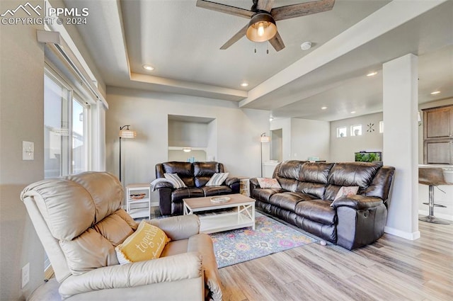 living room with light hardwood / wood-style floors and ceiling fan