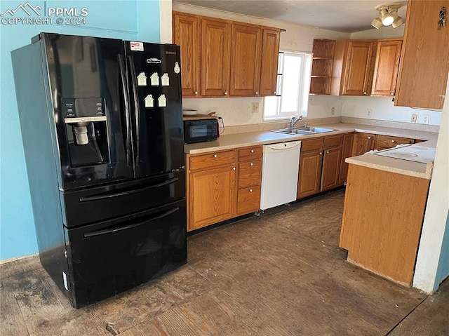 kitchen with black appliances, sink, and dark hardwood / wood-style floors