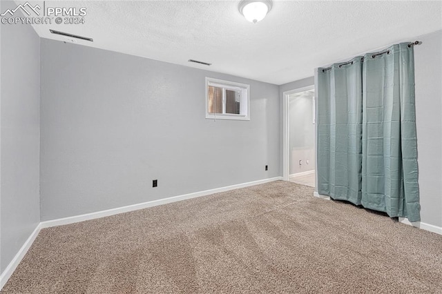 unfurnished bedroom featuring carpet flooring and a textured ceiling