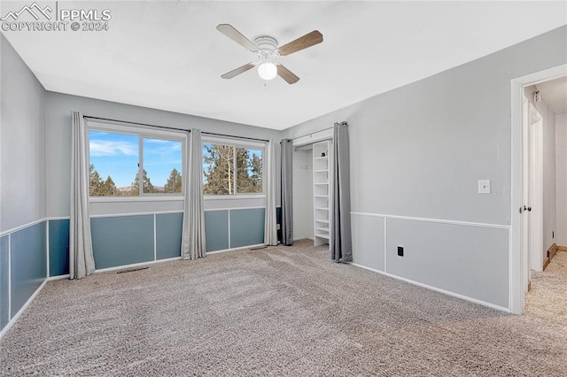 unfurnished bedroom featuring carpet floors and ceiling fan