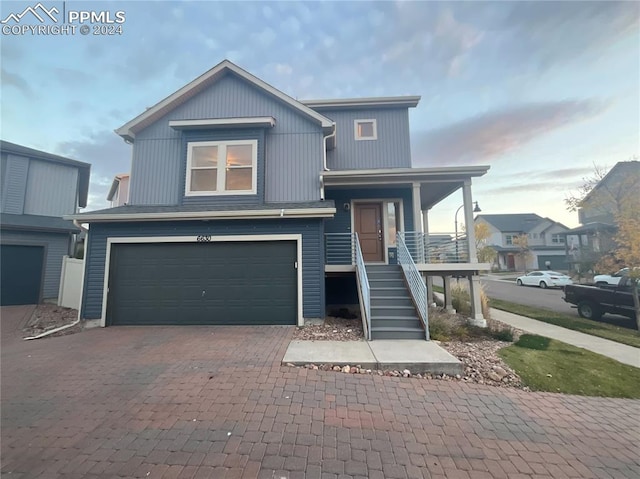 view of front facade featuring a porch and a garage