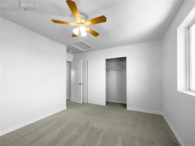 unfurnished bedroom with a closet, light carpet, multiple windows, and ceiling fan