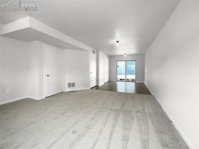 empty room with dark colored carpet