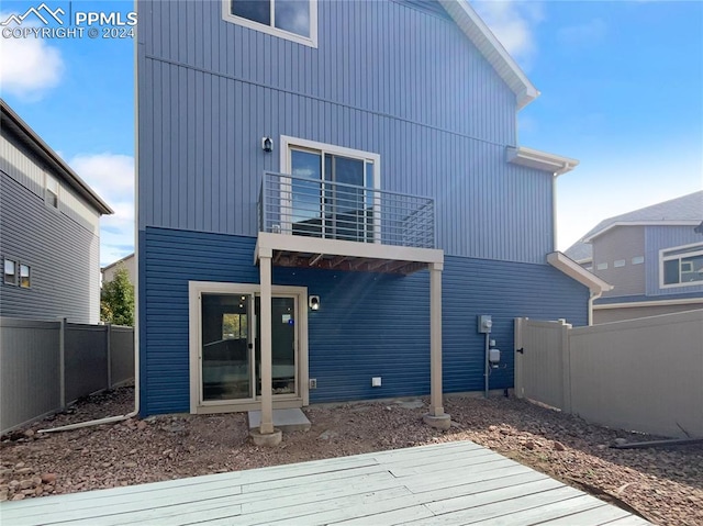 back of house featuring a wooden deck