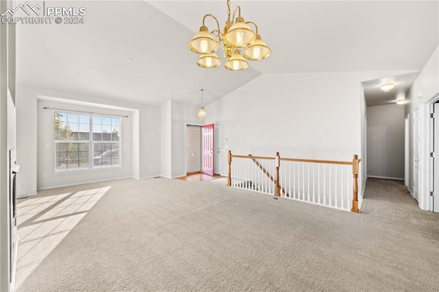 spare room with lofted ceiling and light colored carpet