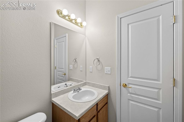 bathroom featuring vanity and toilet