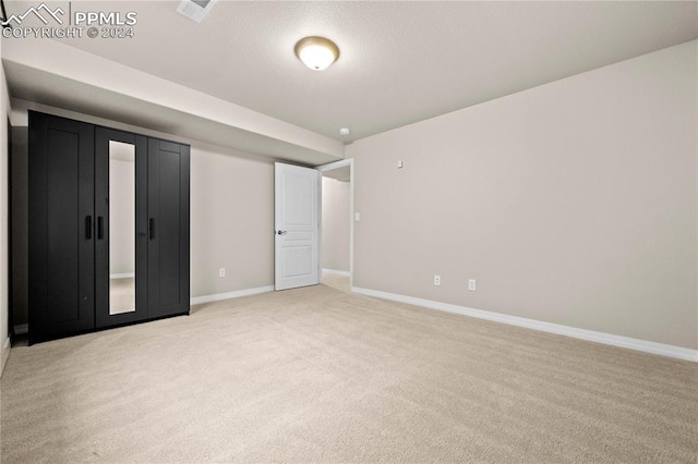 unfurnished bedroom with light colored carpet